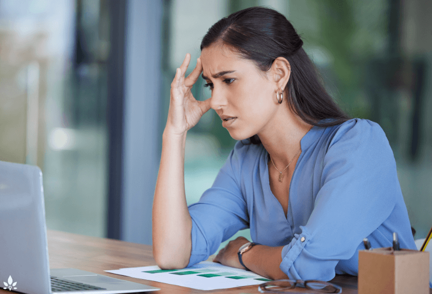 A woman with health concerns looks anxiously at her computer screen.